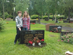 My grandmother and I posing for a picture at my grandfather's grave site in  Oulu, Finland after cleaning it up and planting flowers there during my and my mother's trip to Finland in July 2012. 