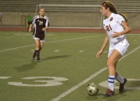 Junior forward, Sarah King, carefully drives the ball down field, before taking a shot on goal. King scored the only goal of the game for the Cowgirls. Coppell defeated Plano, 1 to 0. Photo by Julia Olson.