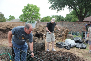 Scott Burnside and Jim Meyer turn over their compost at one of Coppell’s community gardens Saturday morning during a composting class. Photo by Nicole Messer.