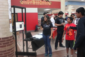 Junior Ruth Fernandes shows community members the first mock up of Gateways, an new inventions for the special needs students, at the STEM Expo. Photo by Gabby Sahm.