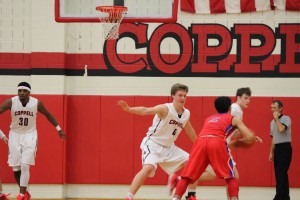 Sophomore Sam Marshall guards a Grapevine player in last night's game at Coppell High School. Marshall lead the team in scoring with 11 points. Photo by Kelly Monaghan.