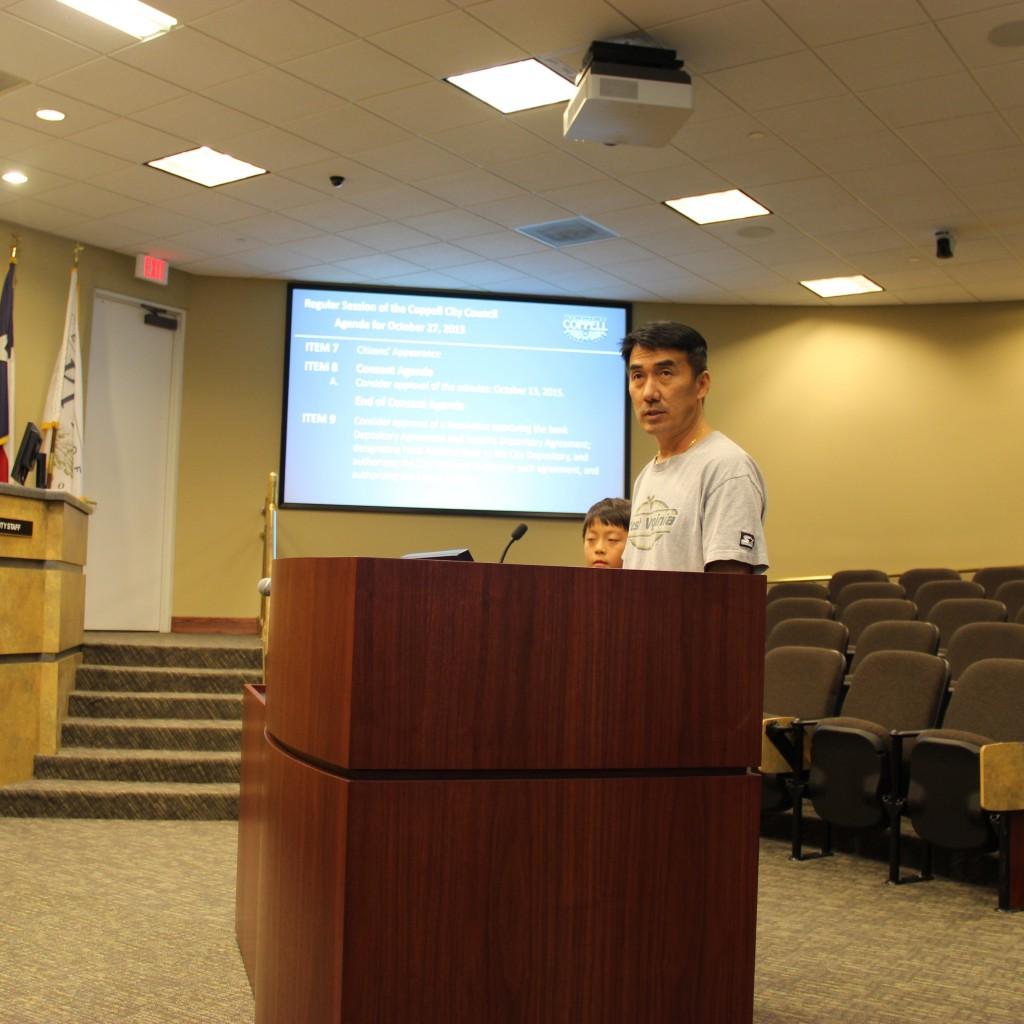 Coppell resident John Jun and his son Samuel Jun propose a need for long-term speed limit enforcements on Allen Road during the city council meeting on Tuesday at Coppell City Hall. John Jun is concerned about the safety of children walking home from school along the road. Photo by Jennifer Su.