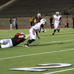 Coppell High School senior defensive lineman Frankie Morgan attempts to tackle Haltom ball carrier. Coppell beat Haltom 44-6 at Buddy Echols Field on Friday night. Photo by Megan Winkle