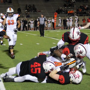 Coppell High School football players tackle the Haltom player with the ball during the third quarter. The Cowboys defeated the Buffalos Friday night at Buddy Echols Field 44-6. Photo by Megan Winkle 