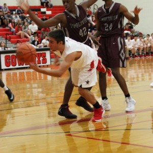 Coppell High School senior guard Alex Vuchkov is double blocked by Mansfield Timberview players. The Cowboys beat the Wolves Friday at home in the large gym 54-52.