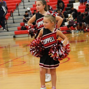Coppell youth cheerleader performs a routine during halftime at the Varsity Basketball game against Mansfield Timberview. The cheerleaders helped the cowboys beat the Wolves Friday at home in the large gym 54-52.