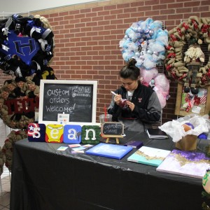 Texas Tech student Nicole Hragyil decorates an ornament on Nov. 15 at the Coppell Holiday House at Coppell High School. She decorates and sells seasonal wreaths and ornaments on her etsy store. Photo by Jennifer Su.  