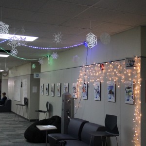 Coppell High School senior IB students Saman Hemani and Lea Balcerzal put up snowflakes and lights down the IB hallway on Monday. They both contributed lots of time and effort to show the Christmas spirit. 