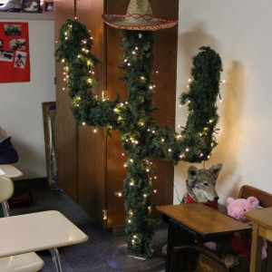 Coppell High School Pre-AP Spanish II teacher Judy Garrett puts up lights around a cactus in her classroom.  