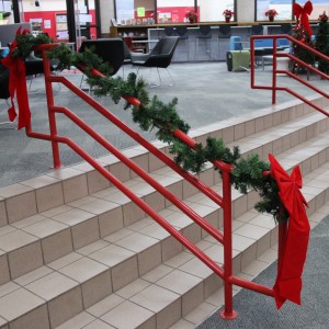 Coppell High School library teachers put up decorations around the staircase railings during the holidays. With Christmas break approaching, the library is spreading cheer and bettering the holidays. 