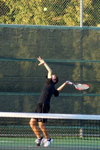 Varsity tennis player Blake Taylor serves the ball at the Southlake game. Photo by Katie Quill