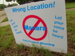 Residents put up signs on their lawn to show opposition