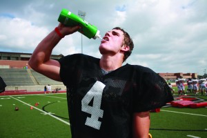 Junior running back Cam McDaniel takes a sip of water to keep hydrated in the heat during football practice.