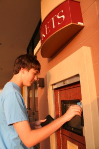Senior Tyler Bagley buys a ticket to see Paranormal Activity. Photo by Frances Ruiz 