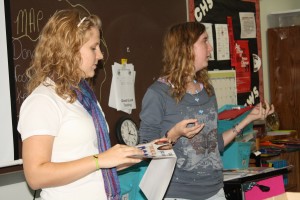 Junior TOMS club vice presidents Lydia White and Sarah Hillier (right) at a club meeting. Photo by Viviana Trevino.