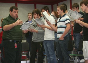 Choir director Jeffrey Schulz directs Madrigals as they prepare for the 15th Annual Feast.