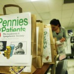 Senior Ellen Cameron counts change from all the students for Pennies for Patients. Photo by Aditi Shrikant.
