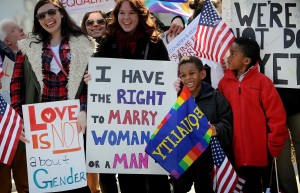 Demonstrators gather in front of the U.S. Supreme Court on Wednesday, March 27, 2013, as the court hers argments on a part of the 1996 Defense of Marriage Act that prevents legally wed same-sex couples from receiving certain benefits by defining marriage as between a man and woman. (Olivier Douliery/Abaca Press/MCT)