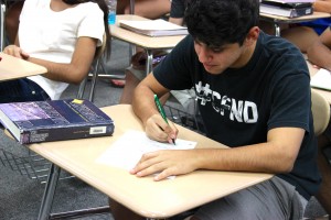 Junior Jose Castillo takes notes with traditional pen and paper in Kevin Casey’s AP US History on Thursday.