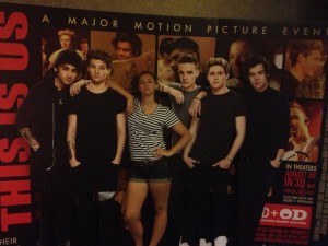 Junior Christianna Haas poses with One Direction cutouts at Grapevine Mills Mall at the Thursday night premiere. Photo by Stephanie Alexander
