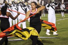 Junior Anna Garza performs a color guard routine with the band during halftime at the football game against McKinney Boyd on Friday, September 6. Coppell beat Boyd, 49-24. Photo by Regan Sullivan.