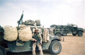 Student Resource Officer Ricky Jimenez poses in front of the fuel truck he drove while he served in Iraq. Photo courtesy Ricky Jimenez.