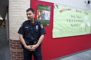 Student Resource Officer Ricky Jimenez stands in the hallway during passing period. Photo by Alyssa Frost.