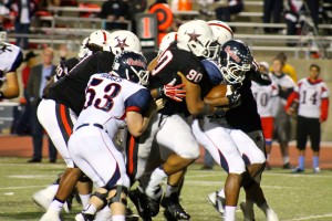 Coppell defensive end Solomon Thomas brings down Denton Ryan player on Senior night to stop a big gain.