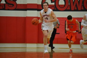 Senior Josh Feitl dribbles the ball down the court in the varsity basketball game against Rockwall. Coppell defeated the Yellow Jackets, 62-58. Photo by Sandy Iyer.