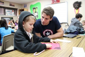 Senior John Herubin helps a Cottonwood Creek Elementary first grader write his letter to Santa. Cottonwood Creek Elementary students visited the high school's English classes on Wednesday. Photo by Sandy Iyer.