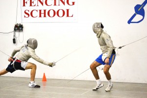 Junior Derek Weix lunges toward a classmate during a practice match at the Husar Fencing School in Addison. Photo by Elizabeth Sims.