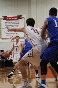 Sophomore guard Josh Fink looks to pass to senior forward Chad Kaiser in Coppell's Feb. 7. matchup against Hebron at Coppell High School. The Cowboys will play their bi-district playoff game against Euless Trinity on Tuesday at Southlake Carroll High School at 7:30 p.m. Photo by Regan Sullivan.