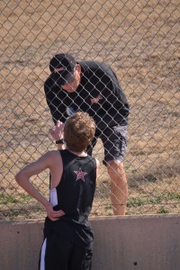 Private running coach Brad Lutz reviews race results with freshman Nathan Sims. Photo by Elizabeth Sims.