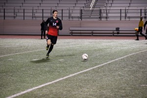 Senior defenseman Kellen Reid controls the ball in the Cowboys' March 7 matchup against Flower Mound Marcus. Coppell finishes its regular season versus Lewisville on March 21. Photo by Shannon Wilkinson.