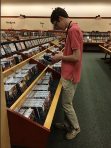 Junior Bobby Manning sorts cds while working at his job at Barnes & Noble on Sunday. Photo by Sandy Iyer. 