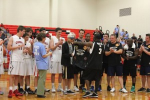 Sophomore Tommy Gantt is awarded a Coppell services jersey at the end of the game on Friday in the large gym. Photo by Nicole Messer.