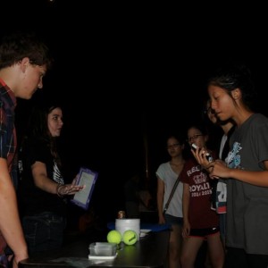  Coppell High School Senior Jessica Melville explains the scale of the universe to Angela Barnes’ AP Earth and Space Science students on Wednesday night at the star party in the CHS parking lot. Using a tennis ball and a shirt button, she explains our size compared to the sun. Photo by Alexandra Dalton. 