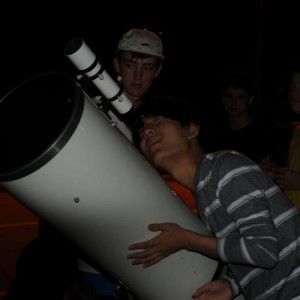 Coppell High School Senior David Kim looks through Angela Barnes’ reflector telescope named Beast to view the moon during the star party on Wednesday night in the CHS parking lot. “Although it’s only a sliver, you can see all of the textures on the moon,” Kim said. “It’s completely insane.” Photo by Alexandra Dalton. 