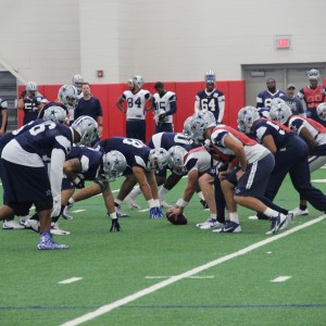 The Dallas Cowboys practice in the newly renovate Coppell High School fieldhouse on Friday. Practice was moved to CHS because of the weather conditions. Photo by Mallorie Munoz.