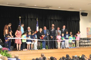 Lee Elementary Principal Chantel Kastrounis and the first kindergarten learner to enroll cut the ribbon.