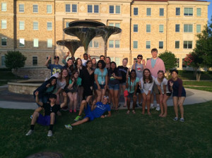 The 23 students at the TCU Schieffer Summer Journalism Program gather around Frog Fountain to one of many photos together. 