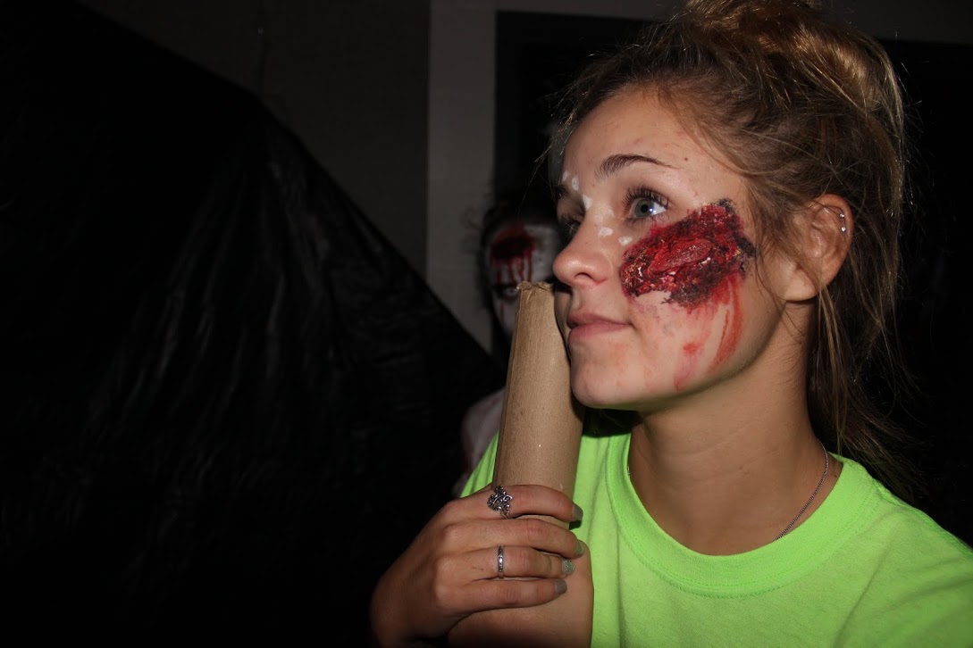 Junior Berkley Bonneau shows her terrifying face makeup off at the New Tech Haunted House on October 23. Bonneau was one of the students who signed up to participate in the haunted house.
