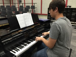 Coppell High School senior Matthew Thomas spends his spare time practicing piano pieces, along with the pieces that he writes. Photo by Nicole Messer.
