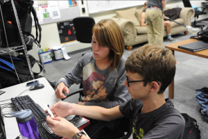 Senior Erin Payne works with fellow STEM junior Ran Trakhtengerts on the development of new technologies the academy is producing to assist in the mental and physical development of the special needs students at Coppell High School. Photo by Sarah VanderPol. 