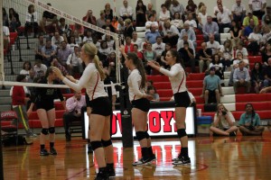 Sophmore Katie Herklotz and seniors Laura Hogan and Kylie Pickrell await a serve during their game against Southlake Carroll last night. 