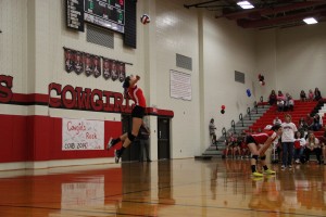 Senior setter Kylie Pickrell jumps to serve on Tuesday night against Colleyville Heritage.