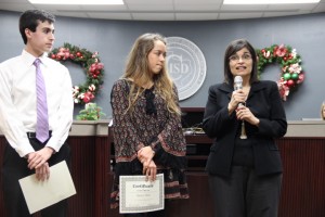 KCBY-TV advisor Irma Kennedy speaks of the crew's hard work and dedication as senior Program Directors Michael Butzer and Hailey Hess receive recognition for winning sixth place in Best of Show for broadcast by the NSPA at the CISD Board of Trustees meeting on Dec. 15. 