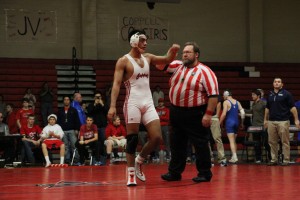 Senior David Murillo is announced the champion of his 160 pound championship Dec. 20. Murillo beat Centennial's Ishon Smith. Photo by Nick Wilson