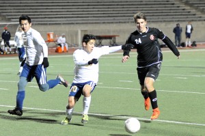 Senior Colten Clark dribbles past an El Paso Coronado in their match on Friday, Jan. 9. Coppell won the match 1-0. Photo by Sarah VanderPol