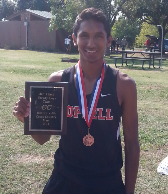 Senior Josh Thomas hold up his team's third place ranking at the district cross country meet on Oct. 23 Thomas was able to help lead his team to get a ranking high enough to qualify them for regionals last fall.